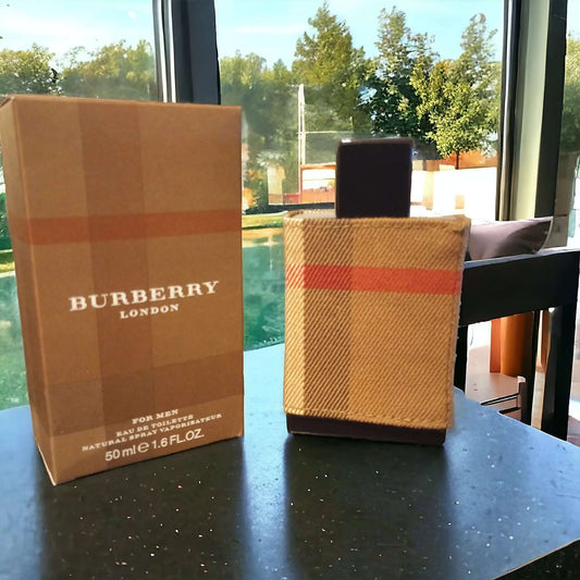 Burberry London perfume bottle and packaging on a table with a window view.