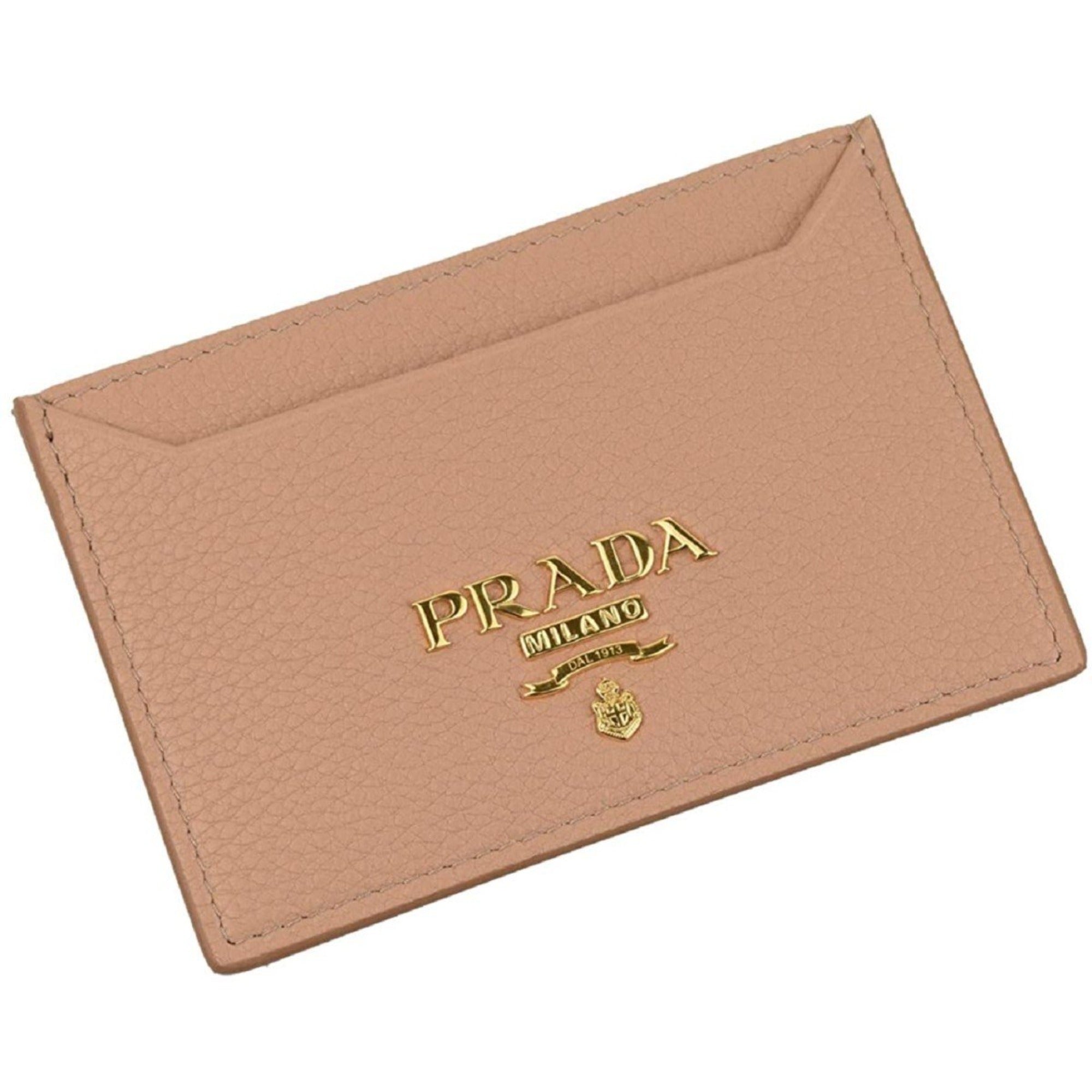 Prada Vitello Leather Card Holder - Sleek & Stylish in Beige - This Prada Card Holder in beige features two card slots and an internal compartment for cash, making it easy to carry your essentials. Its slim design ensures it fits discreetly in your pocket without adding bulk.Model: 1MC208Gold-tone HardwareVitello Grain Beige LeatherTwo card slotsMiddle Slot Available Dimensions: 4 X .1 X 3" (LWH)Includes authenticity cards and dust bagMade in Italy Shop Bags