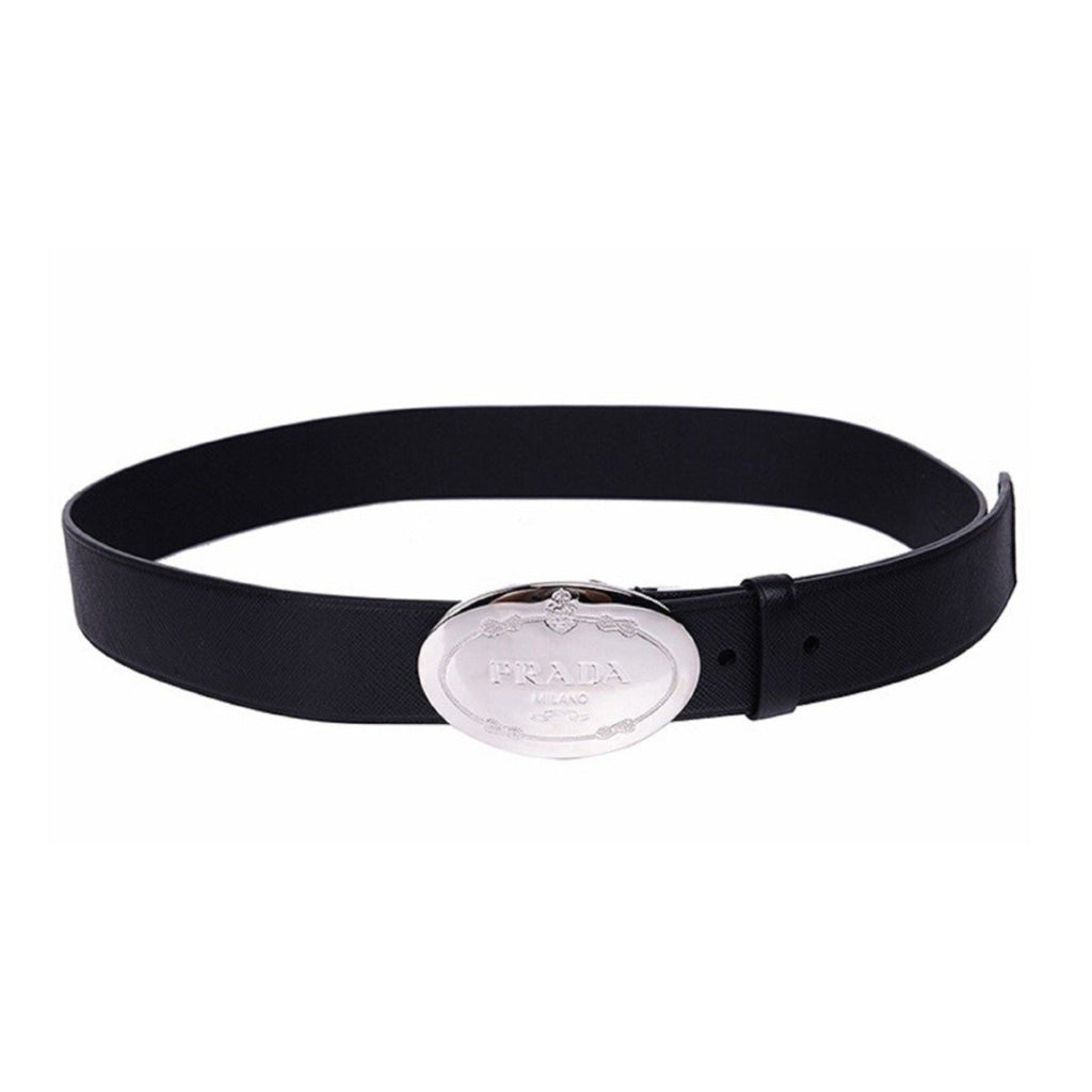 Prada Black Saffiano Leather Belt with Engraved Oval Buckle -  This Belt features black saffiano leather paired with a distinctive oval silver buckle engraved with the Prada logo. Its timeless design makes it a versatile accessory that complements any outfit with sophistication.Model: 2CM046Size: 110/44Black Saffiano LeatherSilver-toned hardwarePalladium plaque buckleIncludes Prada authenticity card and dust bagMade in Italy Shop Bags 