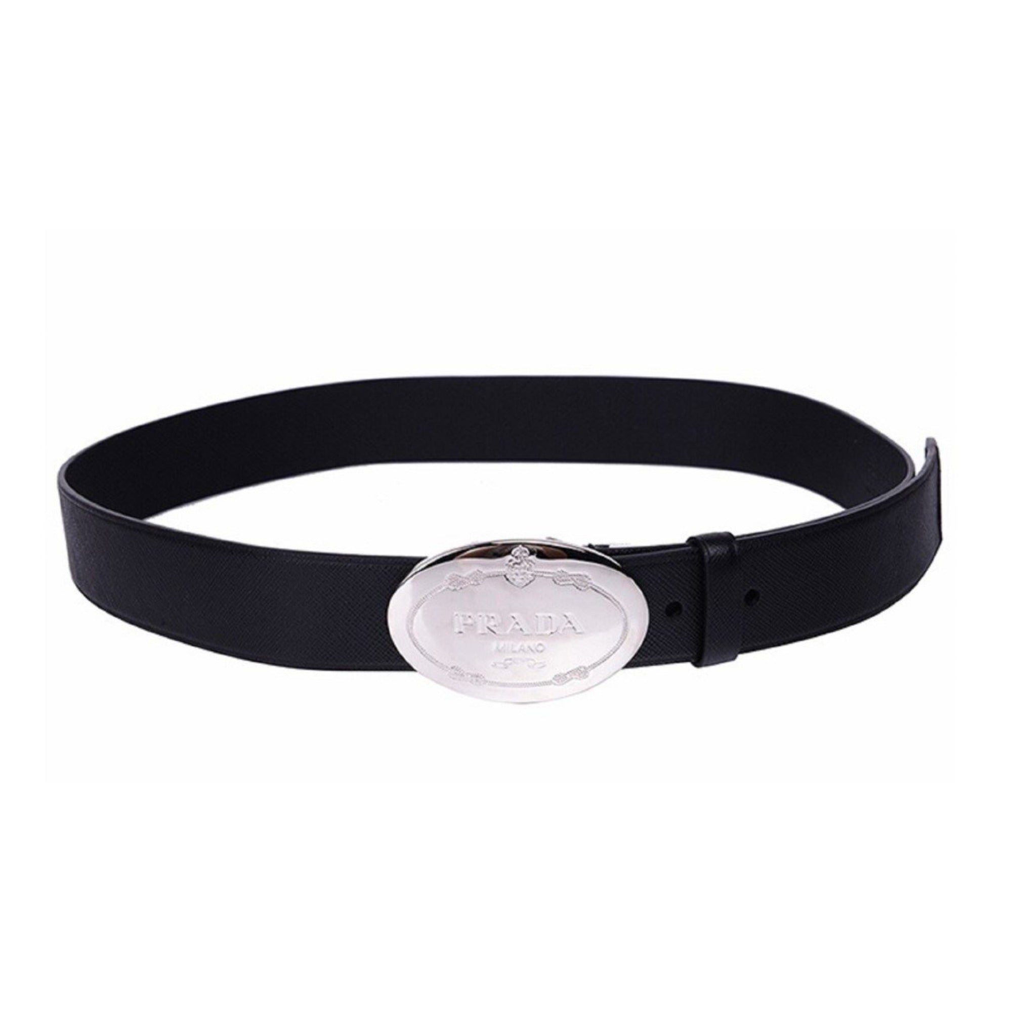 Prada Black Saffiano Leather Belt with Engraved Oval Buckle -  This Belt features black saffiano leather paired with a distinctive oval silver buckle engraved with the Prada logo. Its timeless design makes it a versatile accessory that complements any outfit with sophistication.Model: 2CM046Size: 110/44Black Saffiano LeatherSilver-toned hardwarePalladium plaque buckleIncludes Prada authenticity card and dust bagMade in Italy Shop Bags 