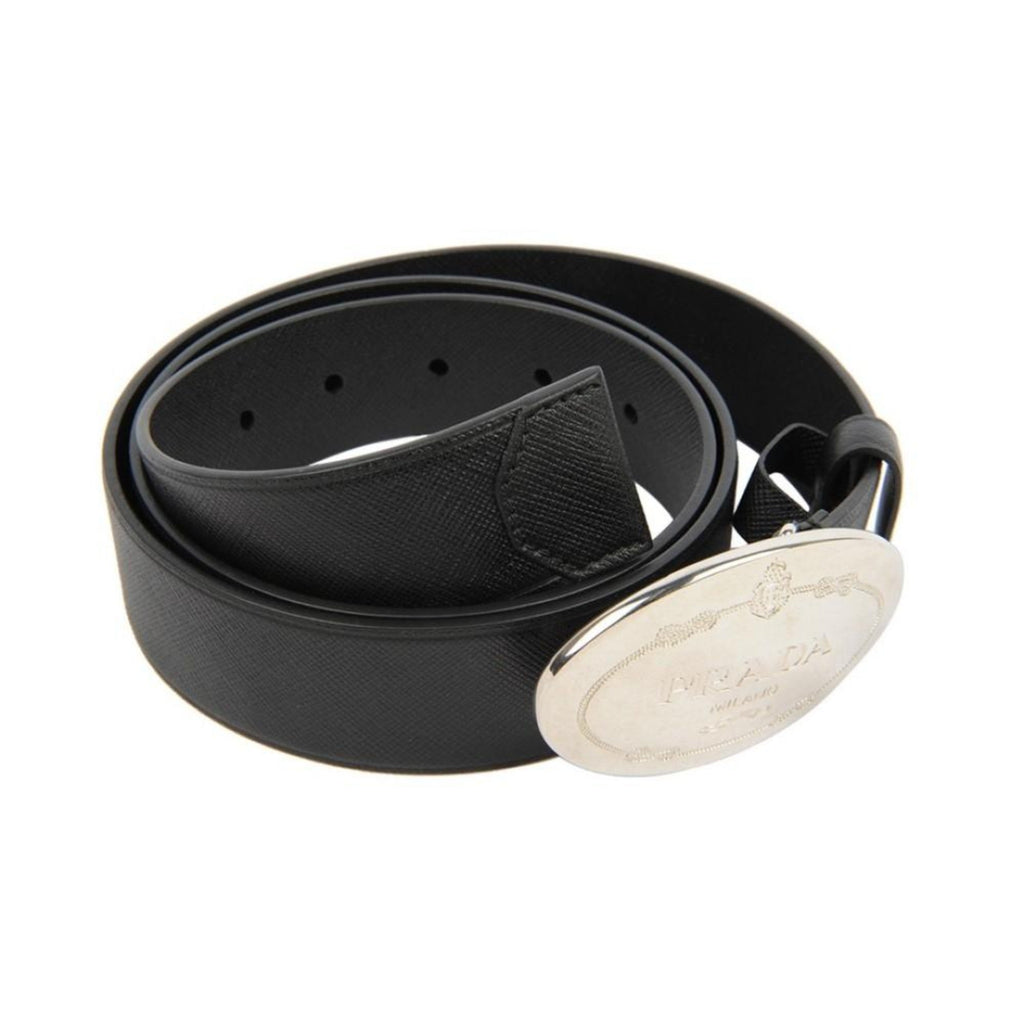Prada Black Saffiano Leather Belt with Engraved Oval Buckle -  This Belt features black saffiano leather paired with a distinctive oval silver buckle engraved with the Prada logo. Its timeless design makes it a versatile accessory that complements any outfit with sophistication.Model: 2CM046Size: 110/44Black Saffiano LeatherSilver-toned hardwarePalladium plaque buckleIncludes Prada authenticity card and dust bagMade in Italy Shop Bags 