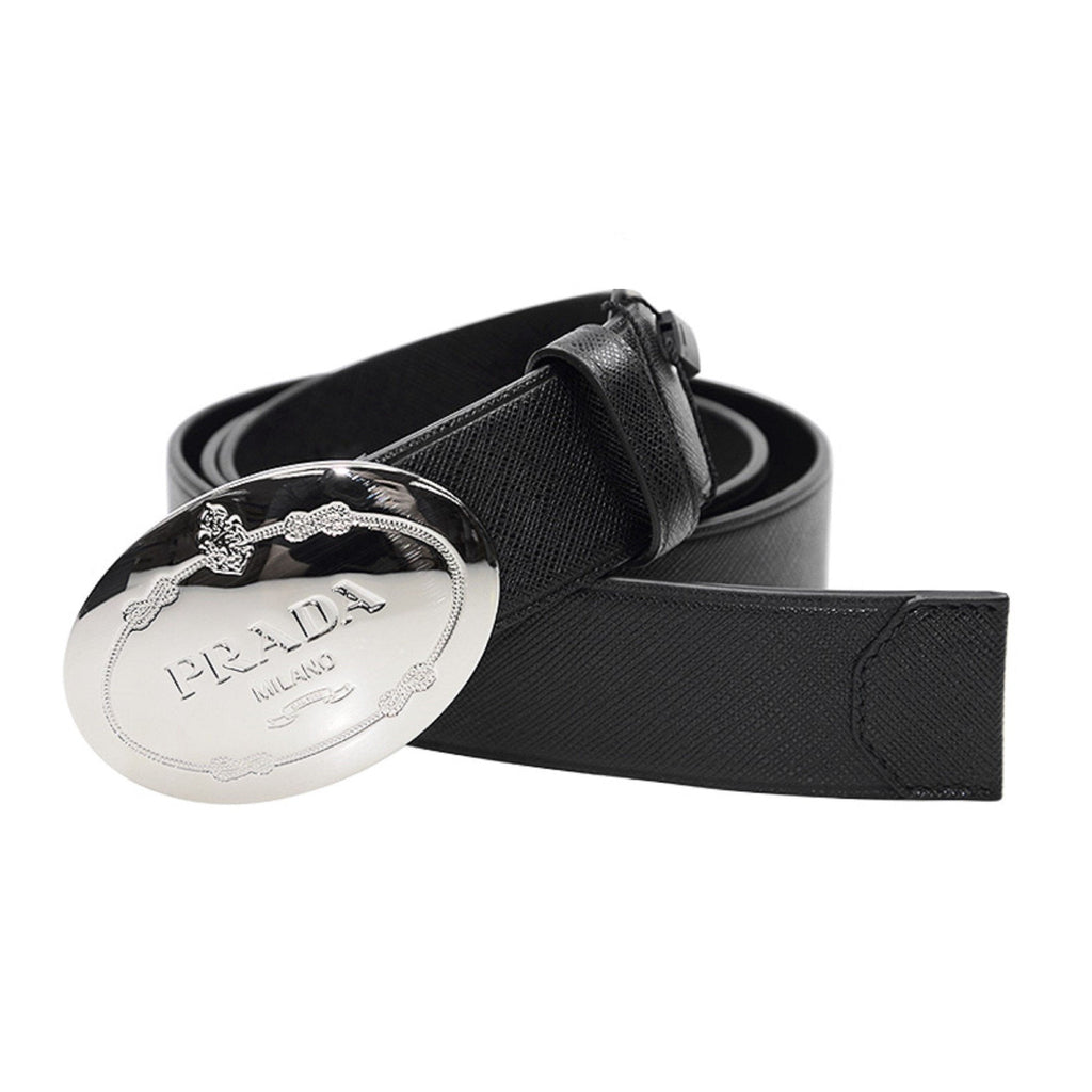 Prada Black Saffiano Leather Belt with Engraved Oval Buckle -  This Belt features black saffiano leather paired with a distinctive oval silver buckle engraved with the Prada logo. Its timeless design makes it a versatile accessory that complements any outfit with sophistication.Model: 2CM046Size: 110/44Black Saffiano LeatherSilver-toned hardwarePalladium plaque buckleIncludes Prada authenticity card and dust bagMade in Italy Shop Bags 