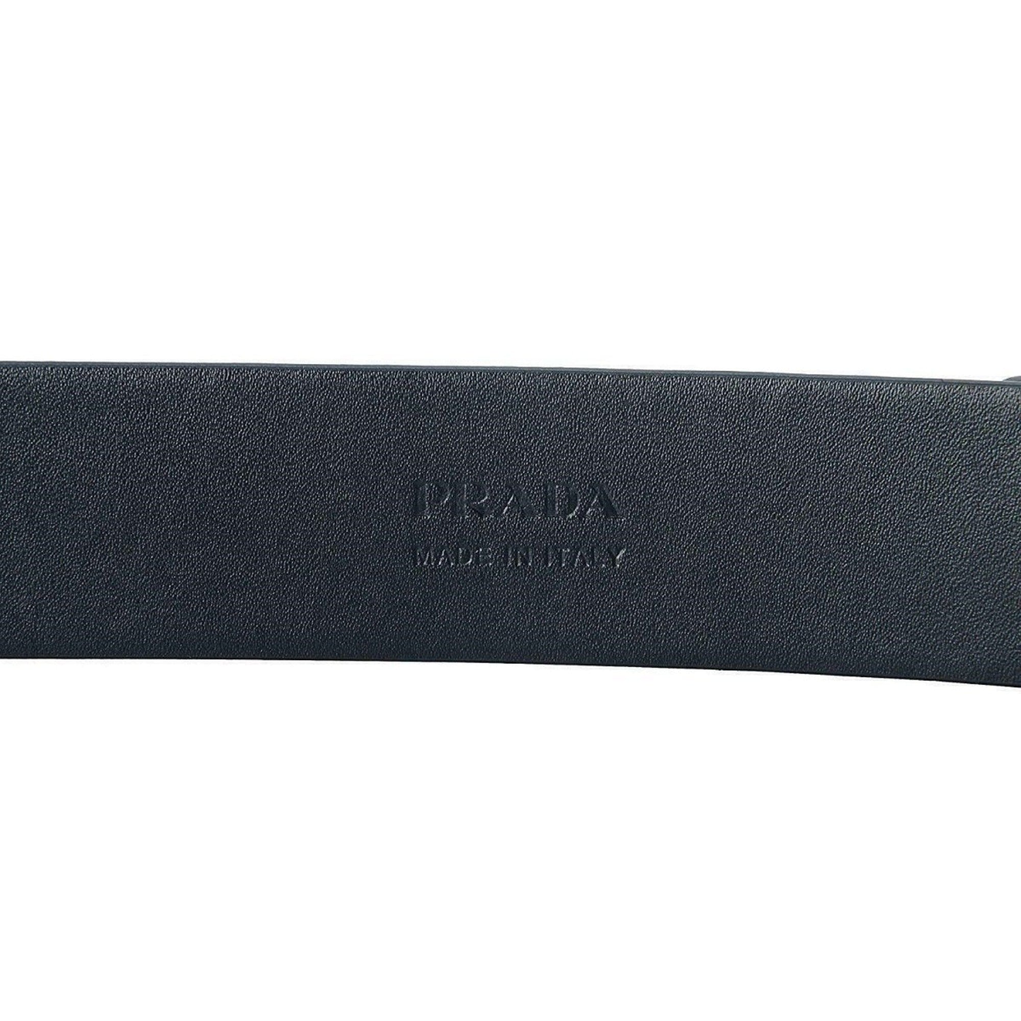 Prada Men's Navy Blue Saffiano Leather Belt with Silver Buckle -  This timeless Prada Belt showcases a matte silver oval buckle engraved with the Prada Milano logo. Crafted from saffiano cross-grain leather, it offers durability and style suitable for daily use.Model: 2CM046Size: 105/42Blue Saffiano leatherBrushed matte silver oval buckleIncludes Prada dust bag and authenticity cardsMade in Italy Shop Bags 
