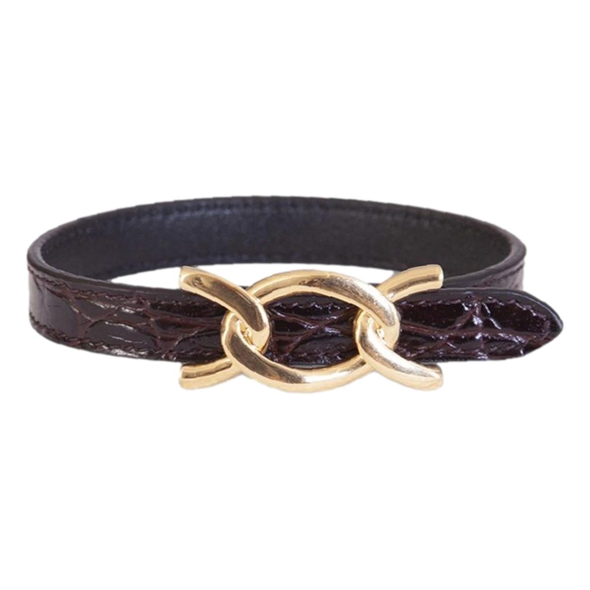 Saint Laurent Croc Embossed Leather Chain Bracelet - Elegance -  This Saint Laurent Bracelet features black leather embossed with a crocodile pattern, paired with a bold gold cub chain. The interior bears a subtle debossed "Saint Laurent" logo. Perfect for elevating daily wear or adding a refined touch to formal ensembles.Model: 640736Calfskin leather with crocodile texture embossedGold curb chain metalAdjustable hook closureSaint Laurent logo embossed on interiorIncludes authenticity cardsMade in Italy