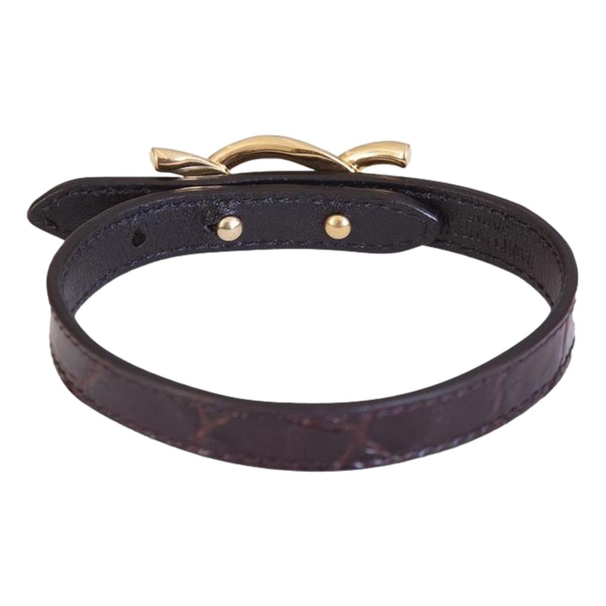 Saint Laurent Croc Embossed Leather Chain Bracelet - Elegance -  This Saint Laurent Bracelet features black leather embossed with a crocodile pattern, paired with a bold gold cub chain. The interior bears a subtle debossed "Saint Laurent" logo. Perfect for elevating daily wear or adding a refined touch to formal ensembles.Model: 640736Calfskin leather with crocodile texture embossedGold curb chain metalAdjustable hook closureSaint Laurent logo embossed on interiorIncludes authenticity cardsMade in Italy