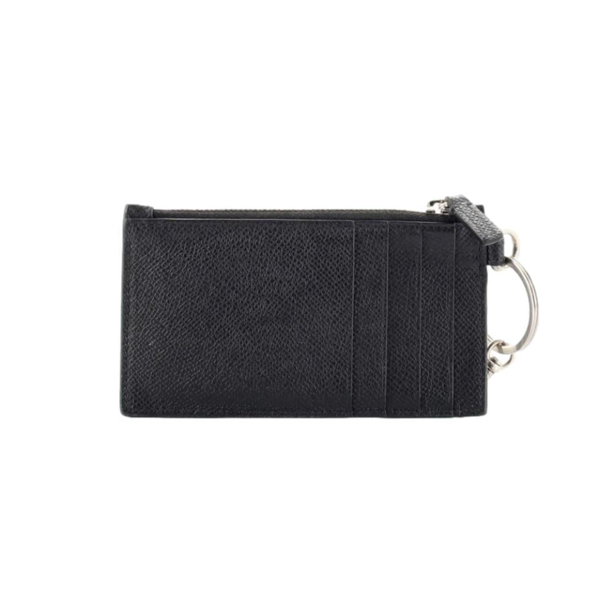 Balenciaga Wallet: Unisex Black Wallet & Card Holder with Lanyard -  Made from black textured leather, this Balenciaga Wallet and card case has a zipped pouch and four card slots, complete with a detachable lanyard for easy portability.Model: 594548Black Calfskin leatherWhite Balenciaga logoBlack leather interior liningFour card slotsTop zipper pocket Detachable leather lanyardStrap drop: 23" Measurements: 5.1 x 0.5 x 3" (LWH)Includes authenticity cardsMade in Italy Shop Bags 