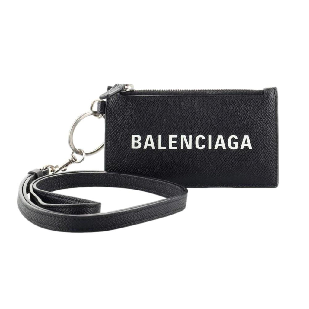 Balenciaga Wallet: Unisex Black Wallet & Card Holder with Lanyard -  Made from black textured leather, this Balenciaga Wallet and card case has a zipped pouch and four card slots, complete with a detachable lanyard for easy portability.Model: 594548Black Calfskin leatherWhite Balenciaga logoBlack leather interior liningFour card slotsTop zipper pocket Detachable leather lanyardStrap drop: 23" Measurements: 5.1 x 0.5 x 3" (LWH)Includes authenticity cardsMade in Italy Shop Bags 