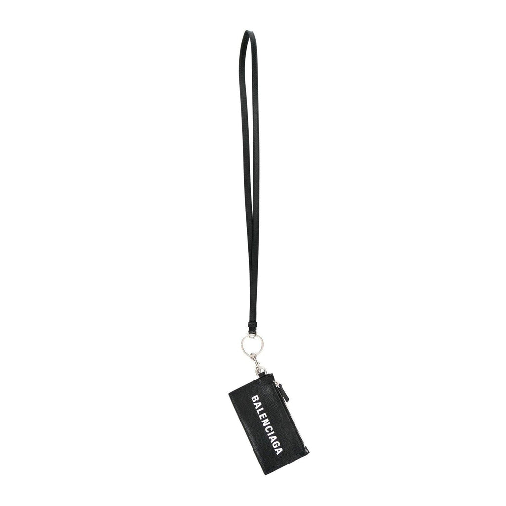 Balenciaga Wallet: Unisex Black Wallet & Card Holder with Lanyard -  Made from black textured leather, this Balenciaga Wallet and card case has a zipped pouch and four card slots, complete with a detachable lanyard for easy portability.Model: 594548Black Calfskin leatherWhite Balenciaga logoBlack leather interior liningFour card slotsTop zipper pocket Detachable leather lanyardStrap drop: 23" Measurements: 5.1 x 0.5 x 3" (LWH)Includes authenticity cardsMade in Italy Shop Bags 
