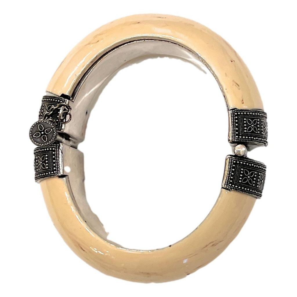 Elegant Saint Laurent Bracelet - Womens Ivory Silver Bangle Bracelet -  This Saint Laurent bangle Bracelet features a blend of oxidized silver brass and ivory-toned resin. Its versatile design complements daily wear and adds a refined touch to your ensemble for special events.Model number: 603598Size: MediumTextured ivory-colored resinSilver oxidized brassScrew-pin closureDimensions: 6.25" inner circumference, 3" outer length, 1" height, 0.5" widthIncludes authenticity cardsMade in Italy Shop Bags 