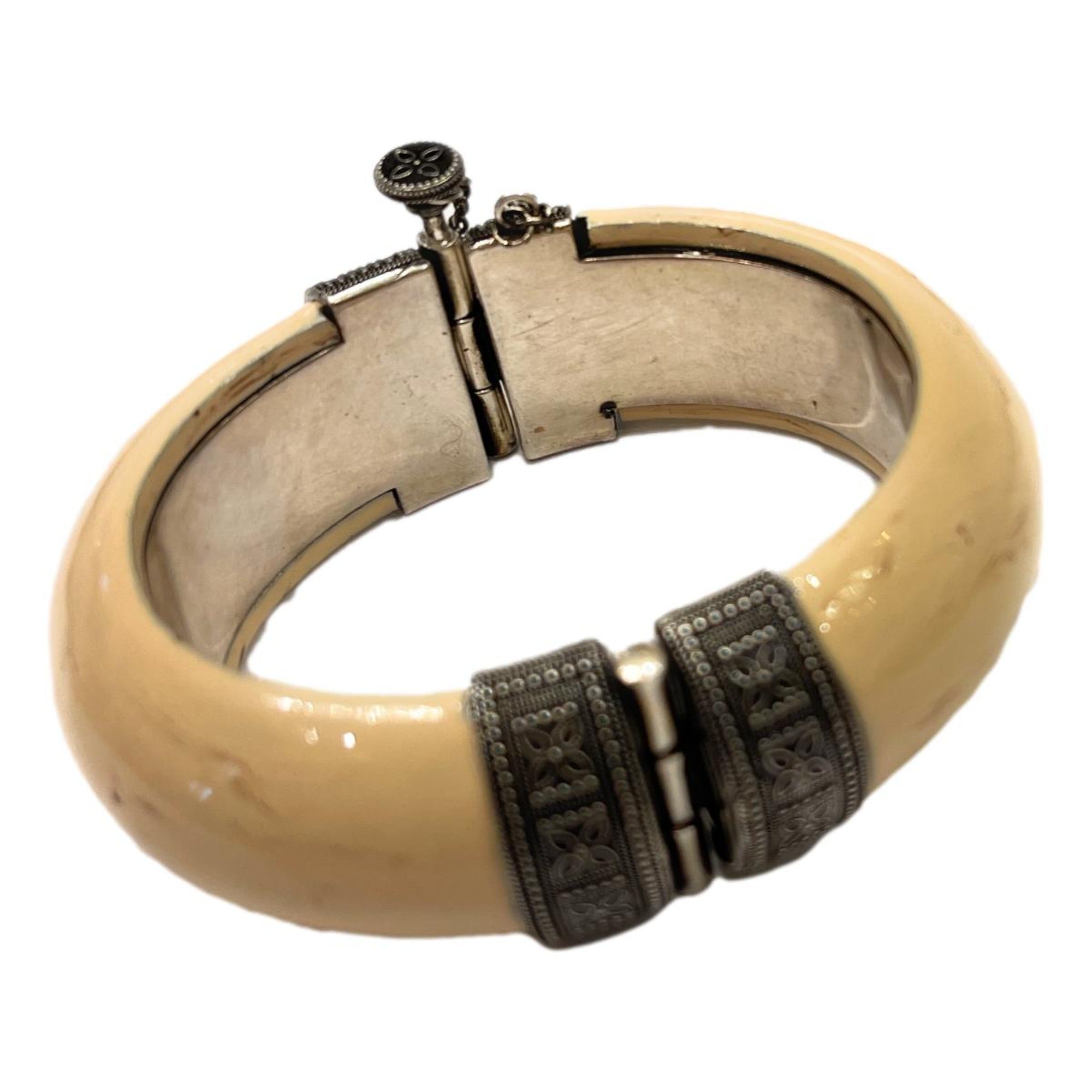 Elegant Saint Laurent Bracelet - Womens Ivory Silver Bangle Bracelet -  This Saint Laurent bangle Bracelet features a blend of oxidized silver brass and ivory-toned resin. Its versatile design complements daily wear and adds a refined touch to your ensemble for special events.Model number: 603598Size: MediumTextured ivory-colored resinSilver oxidized brassScrew-pin closureDimensions: 6.25" inner circumference, 3" outer length, 1" height, 0.5" widthIncludes authenticity cardsMade in Italy Shop Bags 