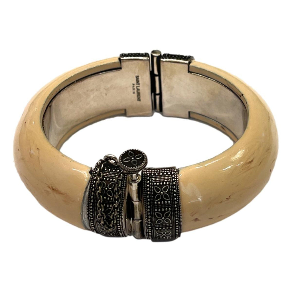 Elegant Saint Laurent Bracelet - Womens Ivory Silver Bangle Bracelet -  This Saint Laurent bangle Bracelet features a blend of oxidized silver brass and ivory-toned resin. Its versatile design complements daily wear and adds a refined touch to your ensemble for special events.Model number: 603598Size: MediumTextured ivory-colored resinSilver oxidized brassScrew-pin closureDimensions: 6.25" inner circumference, 3" outer length, 1" height, 0.5" widthIncludes authenticity cardsMade in Italy Shop Bags 