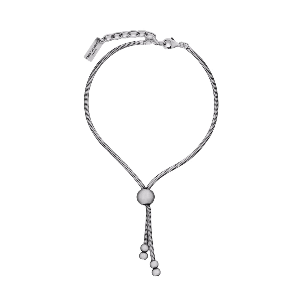 Elegant Tie Bracelet, Shop Bags - Saint Laurent Silver Bolo Style -  The Saint Laurent Silver bolo Tie Bracelet offers a sophisticated twist to elevate your look. Featuring a sleek silver-tone design combined with the iconic bolo tie style, it strikes a refined balance between casual wear and elegant appeal.Model Number: 667365Silver-tone chainLobster claw closureMetal tag with logo embossedAuthenticity cards and box includedMade in Italy Shop Bags 