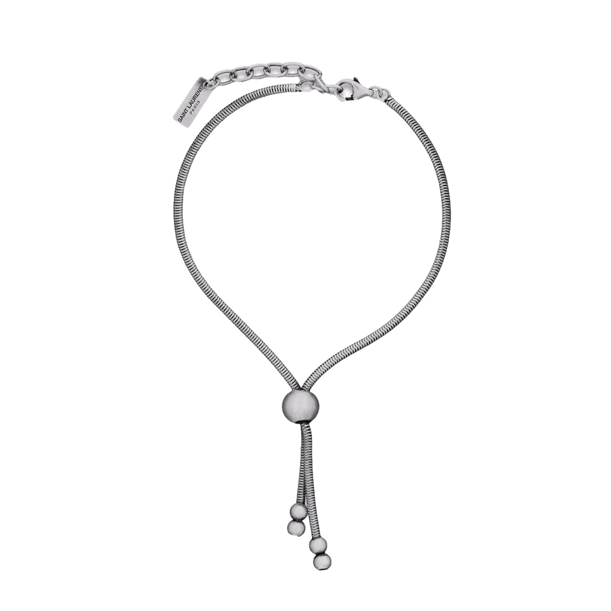 Elegant Tie Bracelet, Shop Bags - Saint Laurent Silver Bolo Style -  The Saint Laurent Silver bolo Tie Bracelet offers a sophisticated twist to elevate your look. Featuring a sleek silver-tone design combined with the iconic bolo tie style, it strikes a refined balance between casual wear and elegant appeal.Model Number: 667365Silver-tone chainLobster claw closureMetal tag with logo embossedAuthenticity cards and box includedMade in Italy Shop Bags 