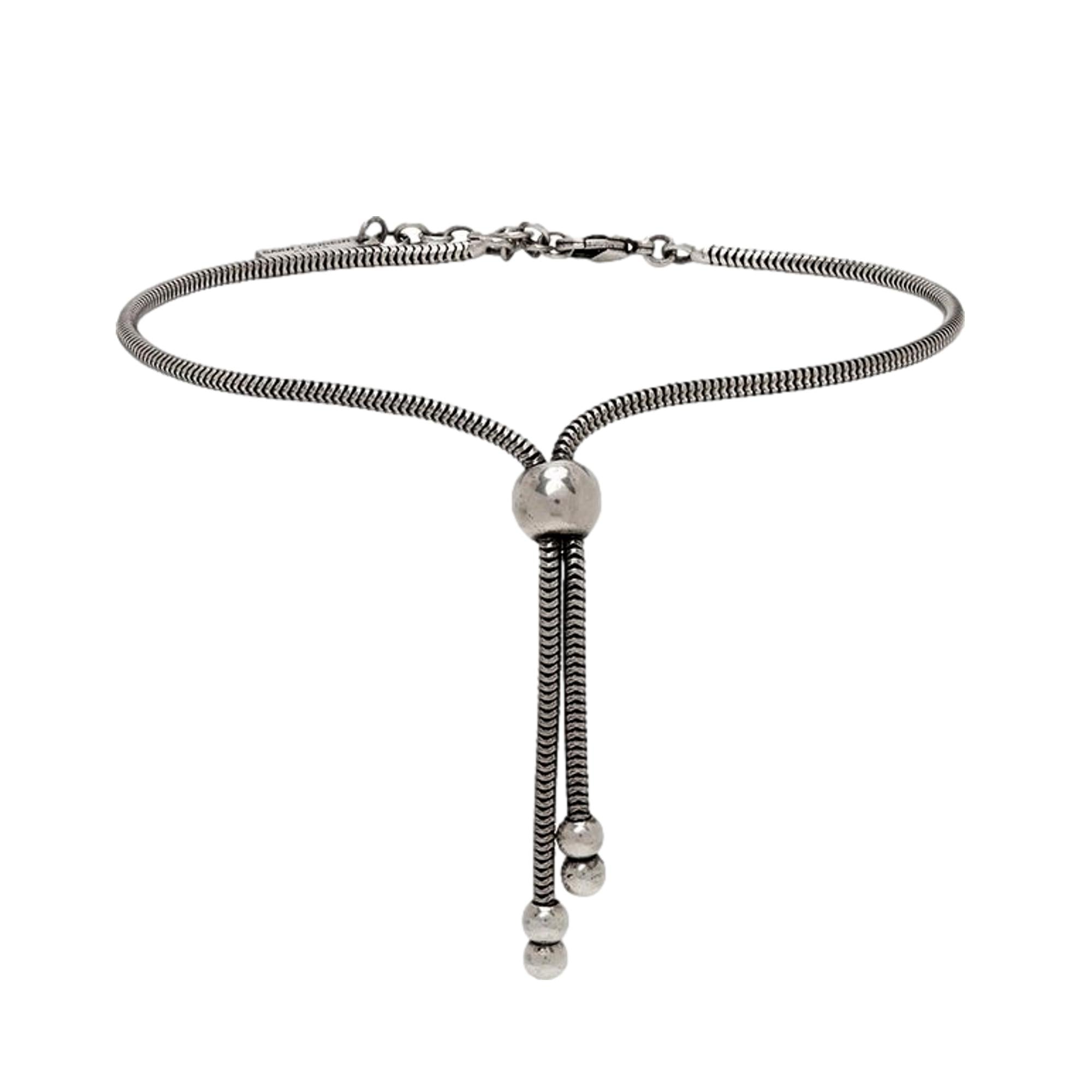 Elegant Tie Bracelet, Shop Bags - Saint Laurent Silver Bolo Style -  The Saint Laurent Silver bolo Tie Bracelet offers a sophisticated twist to elevate your look. Featuring a sleek silver-tone design combined with the iconic bolo tie style, it strikes a refined balance between casual wear and elegant appeal.Model Number: 667365Silver-tone chainLobster claw closureMetal tag with logo embossedAuthenticity cards and box includedMade in Italy Shop Bags 