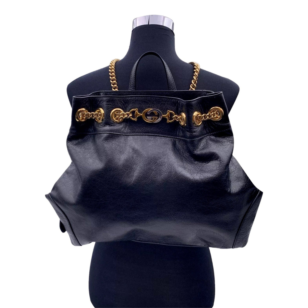 Gucci Zumi: Timeless Black Leather Backpack with Chic Gold Accents