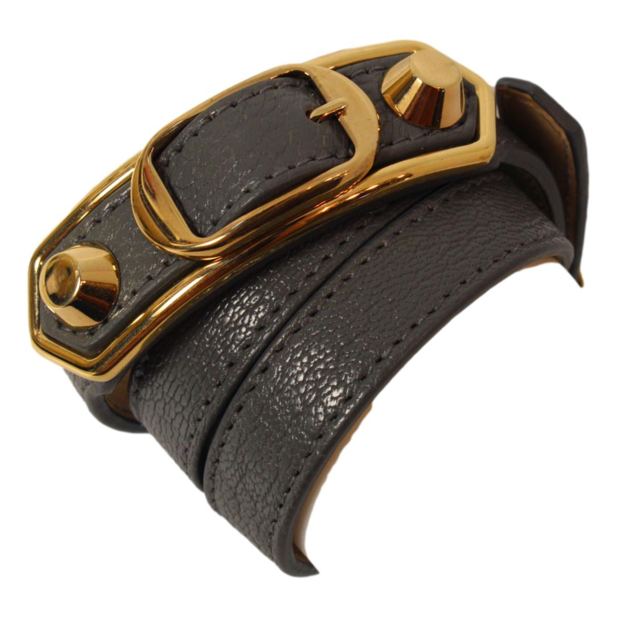 Balenciaga Arena Triple Wrap Studded Leather Bracelet - Dark Grey -  The Balenciaga Arena Triple Tour Wrap Bracelet, crafted from glossy leather, offers a refined yet casual accent to your collection. This elegant leather wrap bracelet introduces a discreet touch of sophistication to any outfit. Model: 390643Arena Triple Tour WrapDark grey leatherGold-tone hardwareBuckle closureMeasurements: Length 20.2“, Width 0.8"Includes authenticity card and boxMade in Italy Shop Bags 