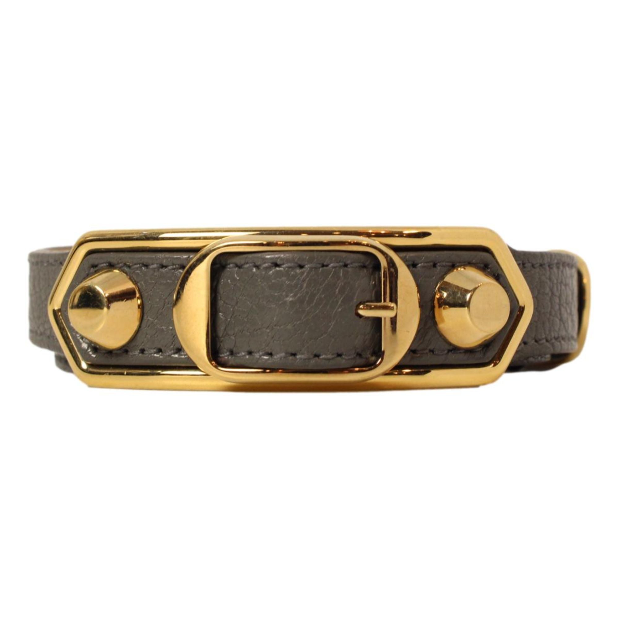 Balenciaga Arena Triple Wrap Studded Leather Bracelet - Dark Grey -  The Balenciaga Arena Triple Tour Wrap Bracelet, crafted from glossy leather, offers a refined yet casual accent to your collection. This elegant leather wrap bracelet introduces a discreet touch of sophistication to any outfit. Model: 390643Arena Triple Tour WrapDark grey leatherGold-tone hardwareBuckle closureMeasurements: Length 20.2“, Width 0.8"Includes authenticity card and boxMade in Italy Shop Bags 