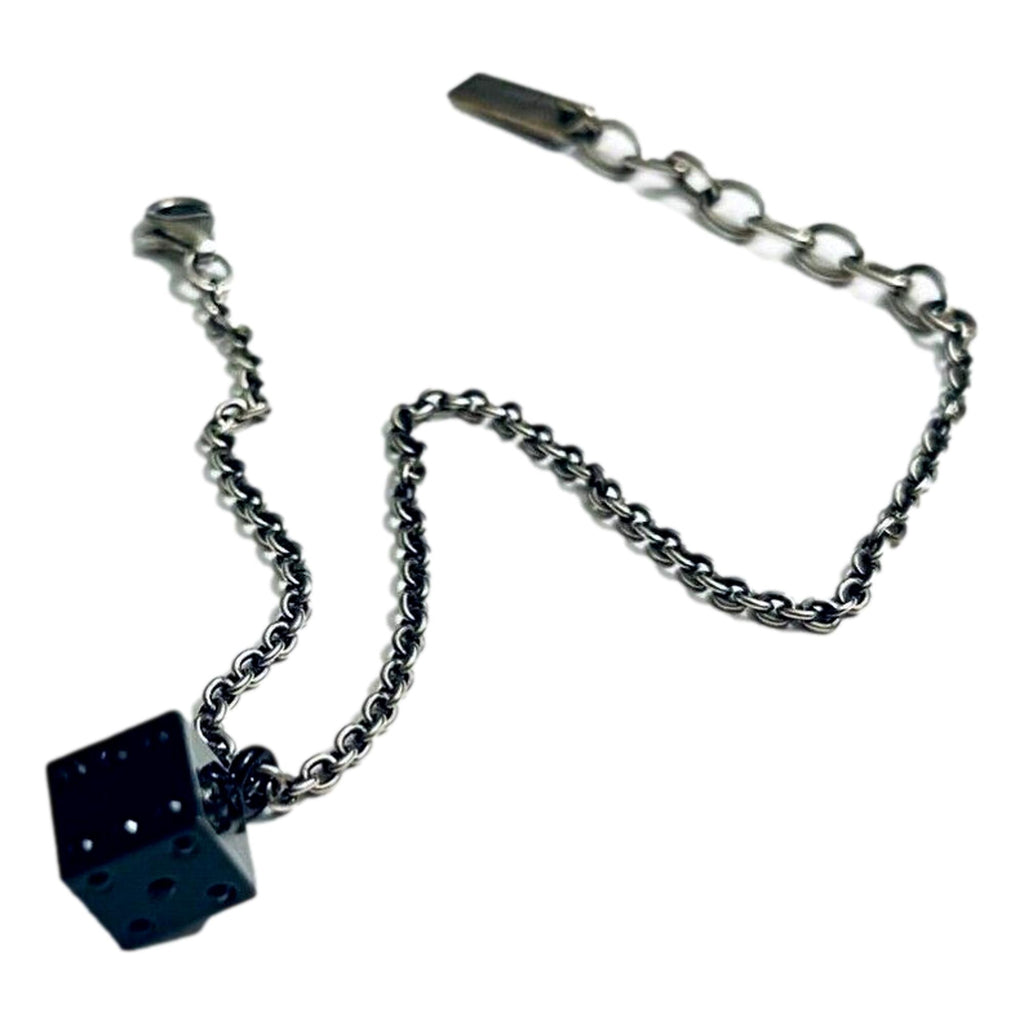 Sleek Saint Laurent Bracelet: Viscose Radio Black & Silver Charm -  The Saint Laurent Des Toile Viscose Radio Chain Bracelet offers a sleek, sophisticated touch to your look. Featuring a silver-tone design complemented by a black dice charm, this bracelet adds subtle boldness and a hint of fortune to your style. Model: 571859Silver-tone chainBlack dice charmLobster claw closureMetal tag with logo embossedIncludes authenticity cards and boxMade in Italy Shop Bags 