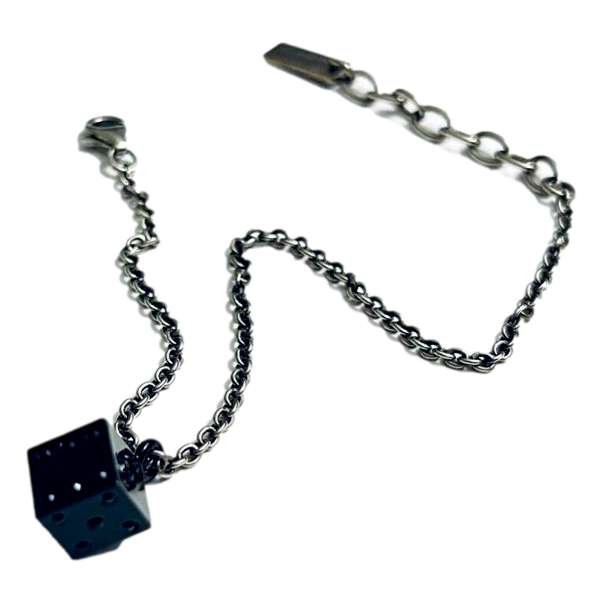 Sleek Saint Laurent Bracelet: Viscose Radio Black & Silver Charm -  The Saint Laurent Des Toile Viscose Radio Chain Bracelet offers a sleek, sophisticated touch to your look. Featuring a silver-tone design complemented by a black dice charm, this bracelet adds subtle boldness and a hint of fortune to your style. Model: 571859Silver-tone chainBlack dice charmLobster claw closureMetal tag with logo embossedIncludes authenticity cards and boxMade in Italy Shop Bags 