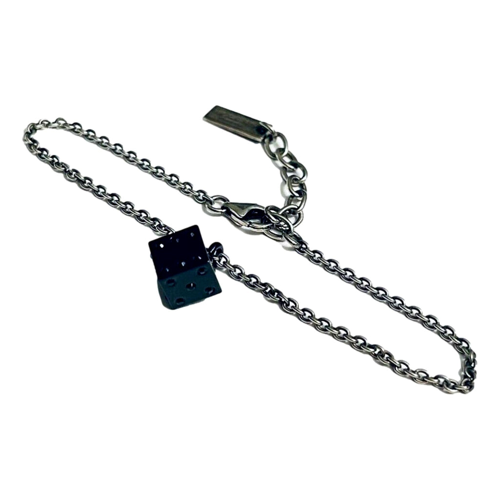 Sleek Saint Laurent Bracelet: Viscose Radio Black & Silver Charm -  The Saint Laurent Des Toile Viscose Radio Chain Bracelet offers a sleek, sophisticated touch to your look. Featuring a silver-tone design complemented by a black dice charm, this bracelet adds subtle boldness and a hint of fortune to your style. Model: 571859Silver-tone chainBlack dice charmLobster claw closureMetal tag with logo embossedIncludes authenticity cards and boxMade in Italy Shop Bags 