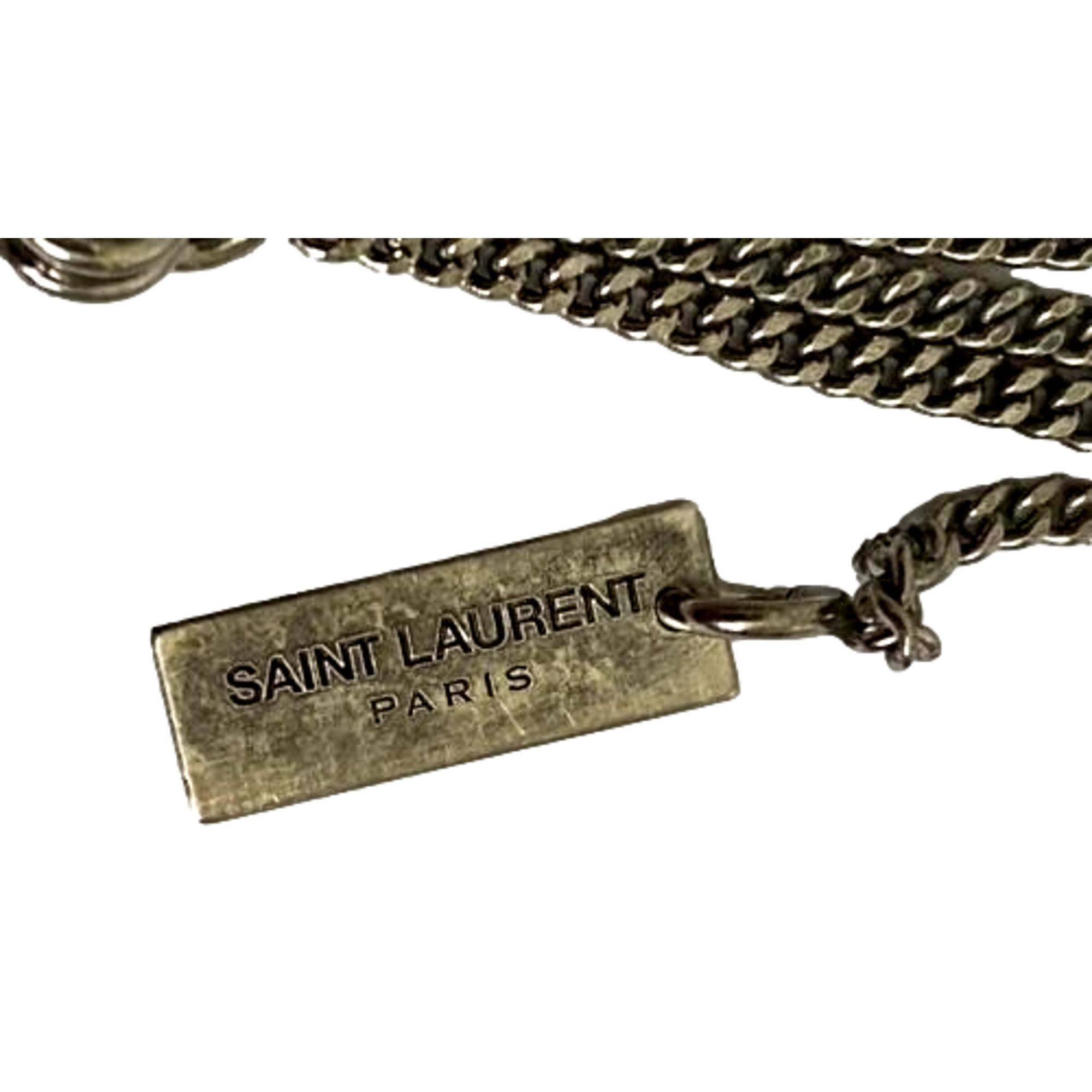 Saint Laurent Agate Necklace, Brass Chain - Elegant Orange-Brown Stone -  The Saint Laurent Agate Necklace combines a lengthy silver brass chain with a lobster claw clasp for adjustable wear. Its semi-precious agate stone showcases warm orange and brown hues, framed in silver. The stone’s color shifts subtly with light and outfit, offering a dynamic and refined accessory. Model: 602594Agate stoneAdjustable chainLobster claw closureIncludes authenticity card and boxMade in Italy Shop Bags 