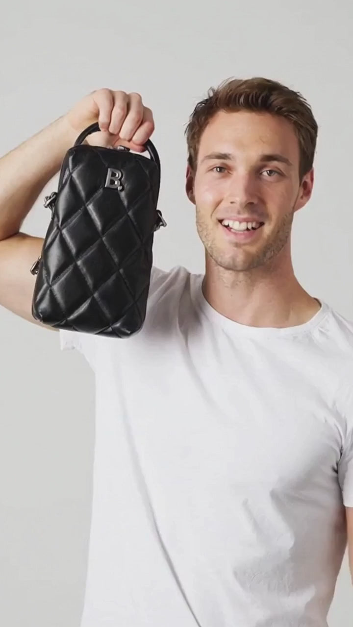 Man showing off a black bag