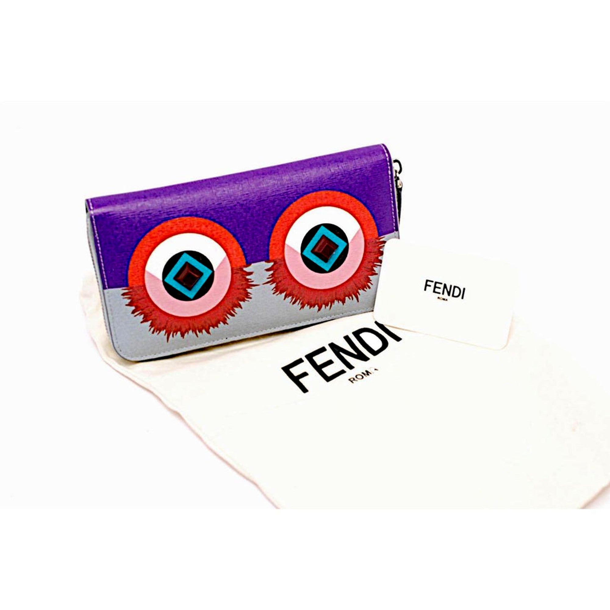 Fendi Monster Clutch: Vibrant Purple Blue Leather Pouch -  This charming Fendi Monster Pouch is an ideal companion for an enjoyable evening. Use it solo, as a wallet, or a cosmetic bag to introduce a vibrant splash of color and sophistication to your ensemble. Model: 8M0341Purple and Blue Leather Silver-tone hardwareZip top closureBlue canvas interior lining Measurements: 7.5" x 0.2"x 4.5" (LWH)Includes authenticity cards and Fendi dust bag Made in Italy Shop Bags 