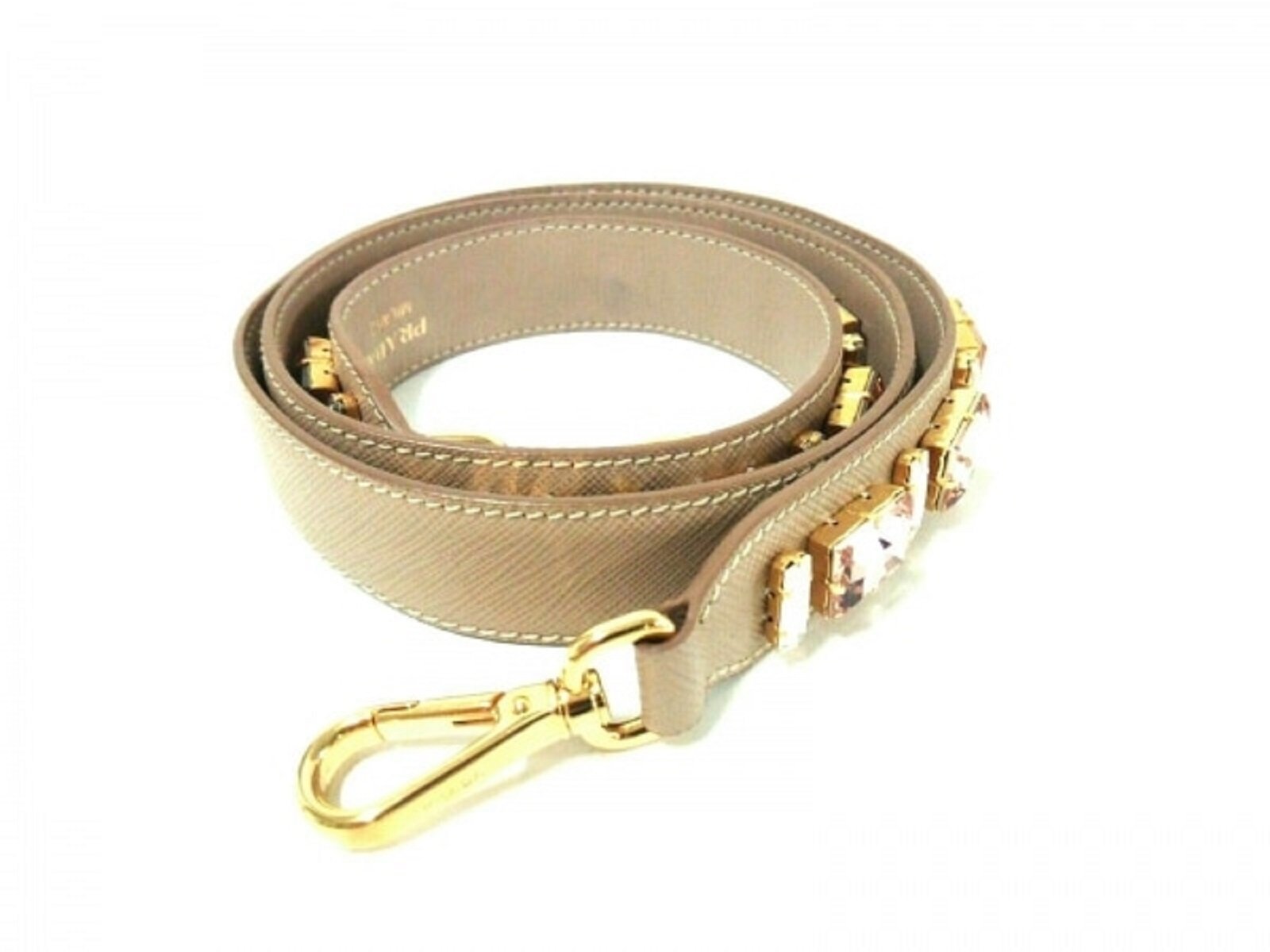 Prada Blush Pink Crystal Strap: Elegant Accessory for Any Handbag -  This elegant Prada Strap adds a subtle touch of sparkle to any handbag. Featuring lobster claw clasps on both ends, it offers effortless attachment for immediate use.Model: 1TY006Cammeo Beige (Blush Pink) Saffiano LeatherJeweledLength: 41inchesIncludes authenticity cards and boxMade in Italy Shop Bags 