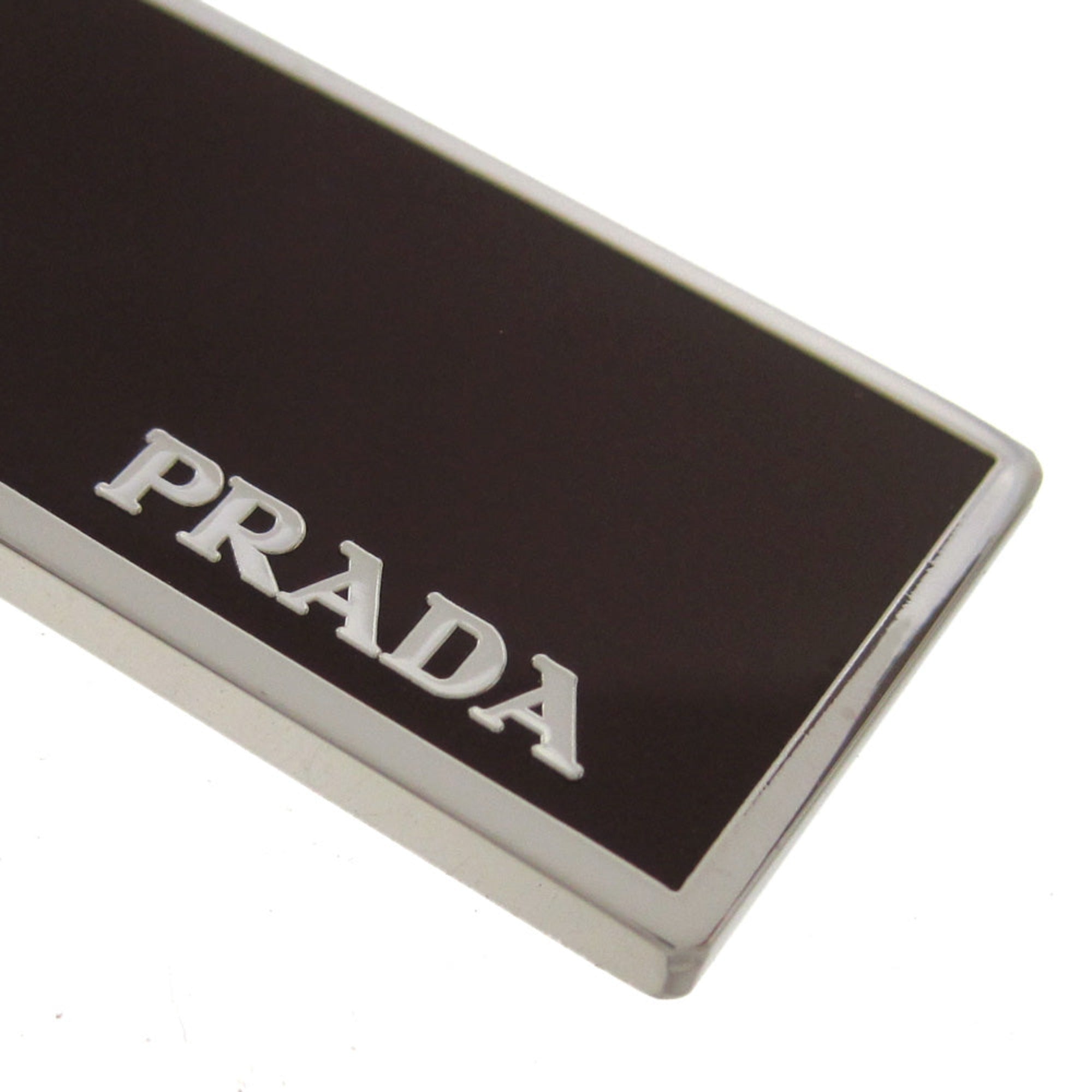Prada Rubino Red Enamel Keychain - Luxury Silver Metal Keyring -  This Prada Keychain features a sleek rectangular silver-tone base topped with deep burgundy red enamel. Designed for both men and women, it offers a sophisticated way to secure keys or accessorize a bag with a touch of luxury.Model number: 2PS021Rubino red enamelSilver-tone metal and key ring, 1.1" diameterMeasurements: 0.6 x 0.1 x 2" (LWH)Includes authenticity cards and Prada boxMade in Italy Shop Bags 